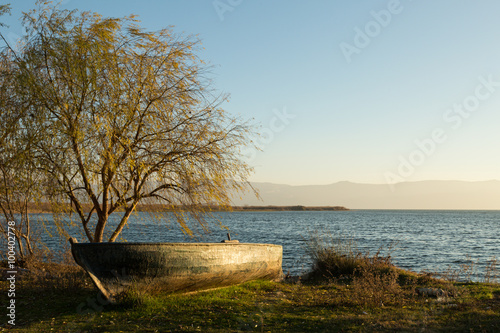 Fototapeta Naklejka Na Ścianę i Meble -  beached boat on the shores of Lake Iznik, Turkey at sunset