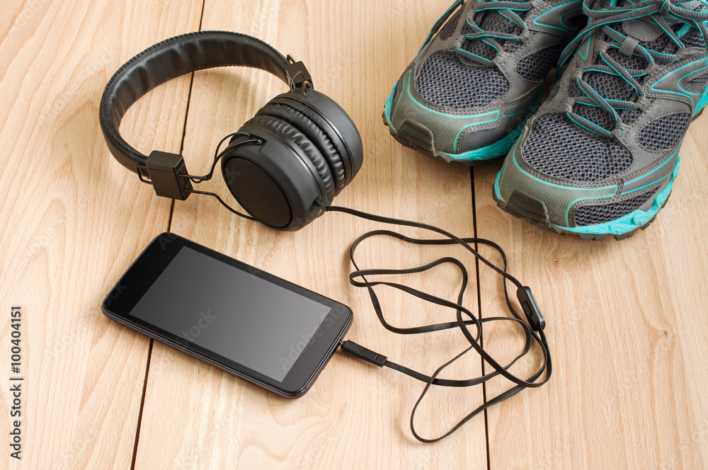 Sport sneakers and smartphone with headphones Sport sneakers and smartphone with headphones
