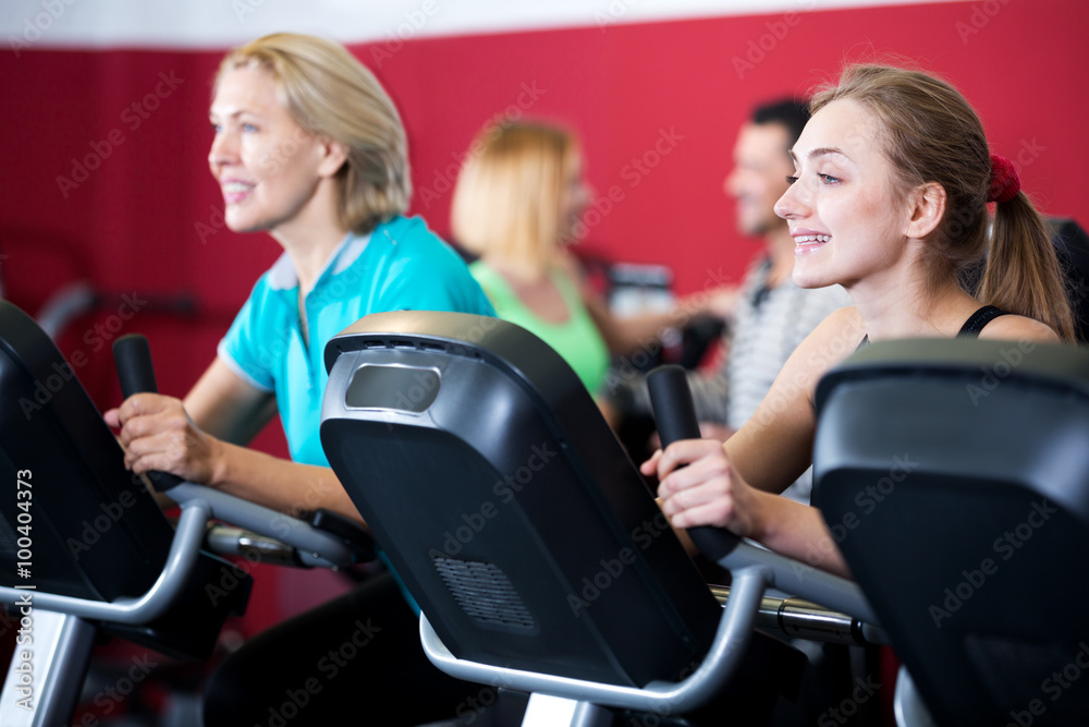 Fototapeta premium People training on exercise bikes together