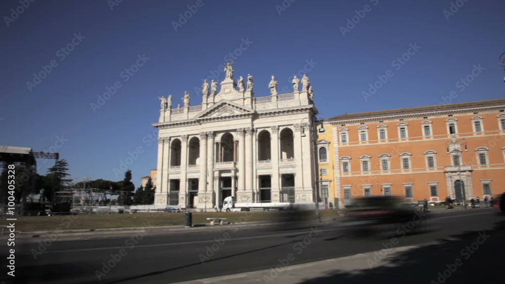 Vehicles and pedestrians on the street before the Archbasilica of St John Lateran Vehicles and pedestrians on the street before the Archbasilica of St John Lateran