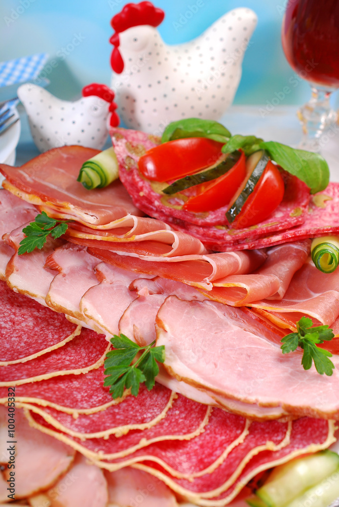 platter of cured meat,ham and salami on eater table platter of cured meat,ham and salami on eater table
