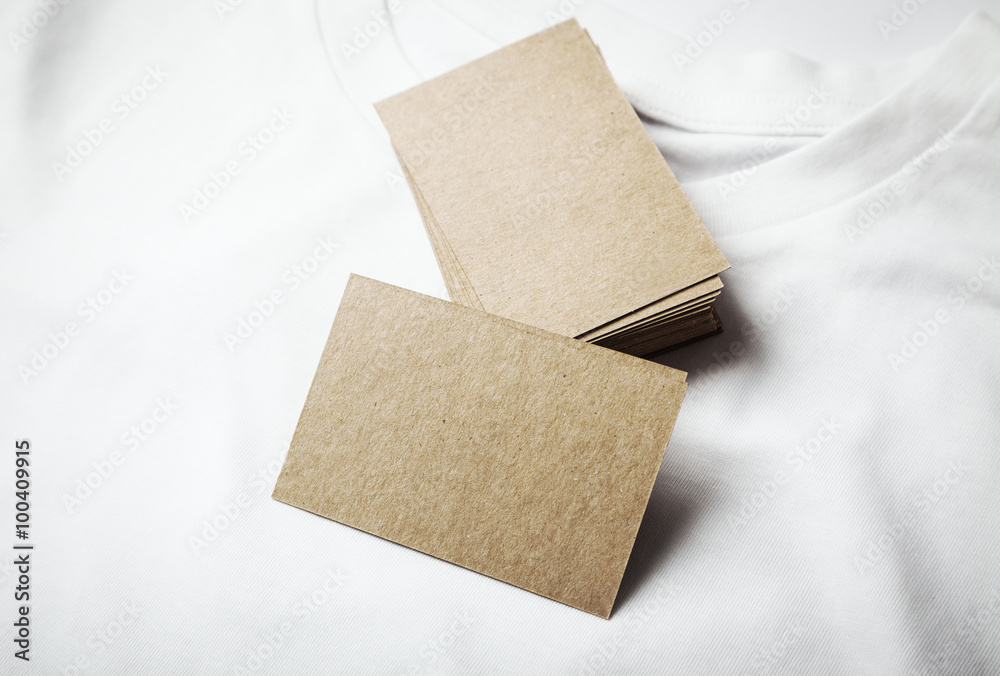 Closeup of blanks craft business cards on white tshirt. Horizontal Closeup of blanks craft business cards on white tshirt. Horizontal
