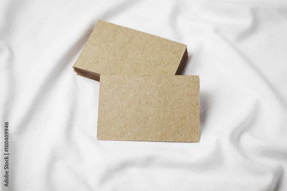 Fototapeta premium Set of blanks craft business cards on white tshirt. Horizontal