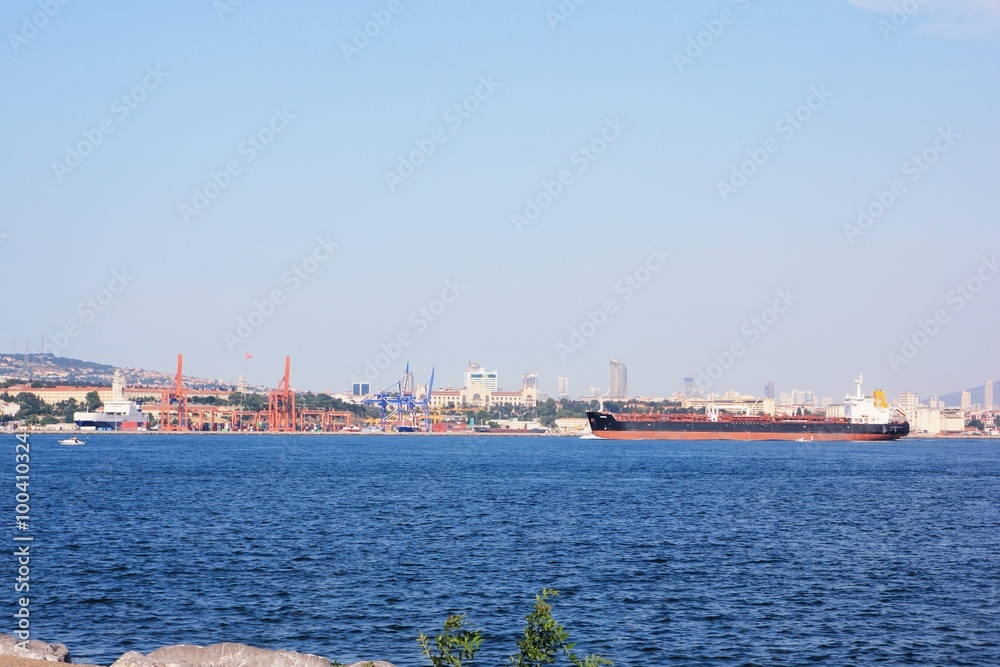 Bosphorus, the cargo ship in the Bosphorus, the clear sky, the bridge over the Bosphorus, Istanbul panorama, passenger ferries, buildings Turkey a large cargo ship crosses the Bosphorus Bosphorus, the cargo ship in the Bosphorus, the clear sky, the bridge over the Bosphorus, Istanbul panorama, passenger ferries, buildings Turkey a large cargo ship crosses the Bosphorus