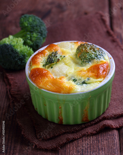 baked broccoli souffle in a green dish
