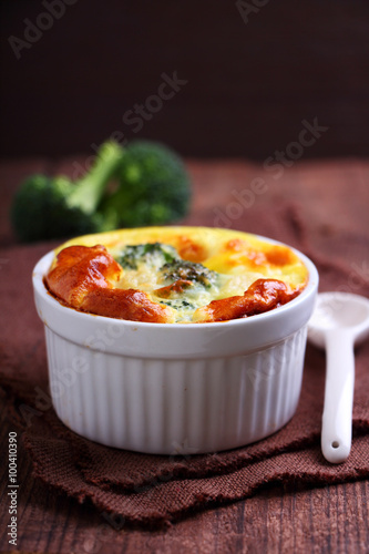 baked broccoli souffle in a green dish