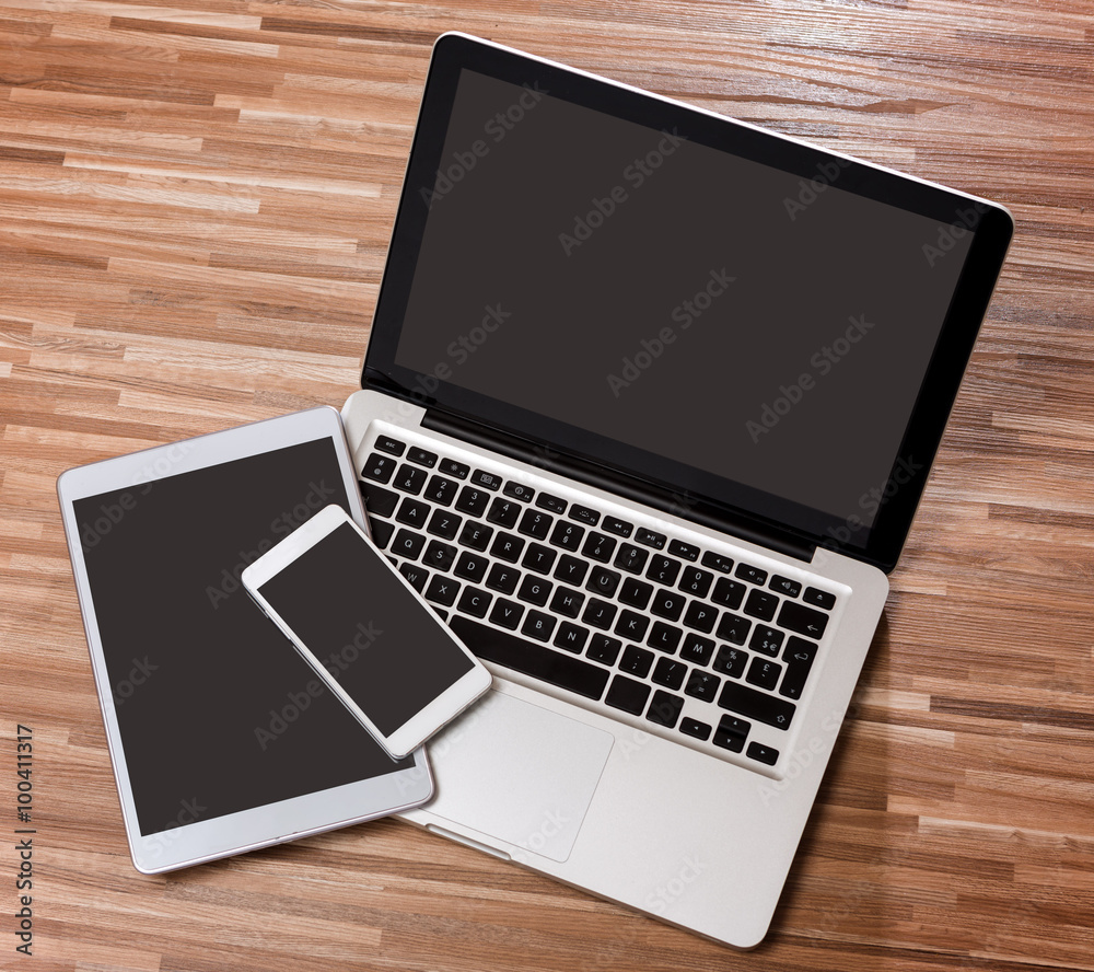 Laptop in high definition with tablet and mobile on a wood backg Laptop in high definition with tablet and mobile on a wood backg