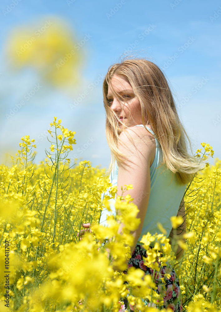 Young happy woman on blooming rapeseed field Young happy woman on blooming rapeseed field