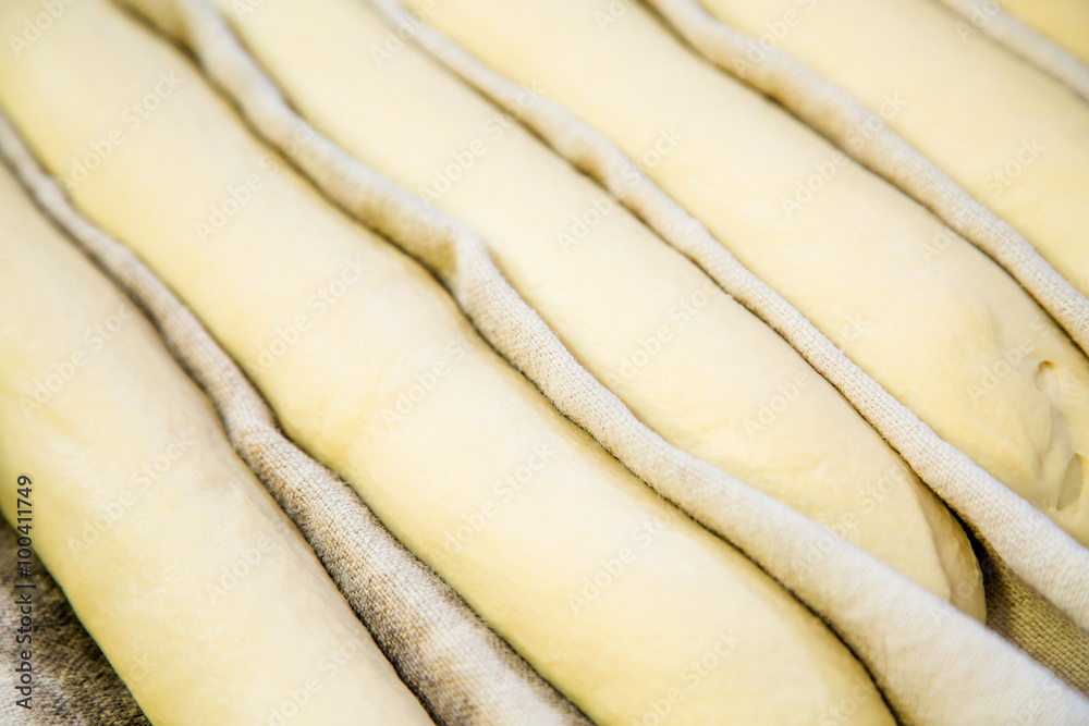 A plain baguette ready to bake on baking tray A plain baguette ready to bake on baking tray