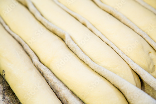 A plain baguette ready to bake on baking tray