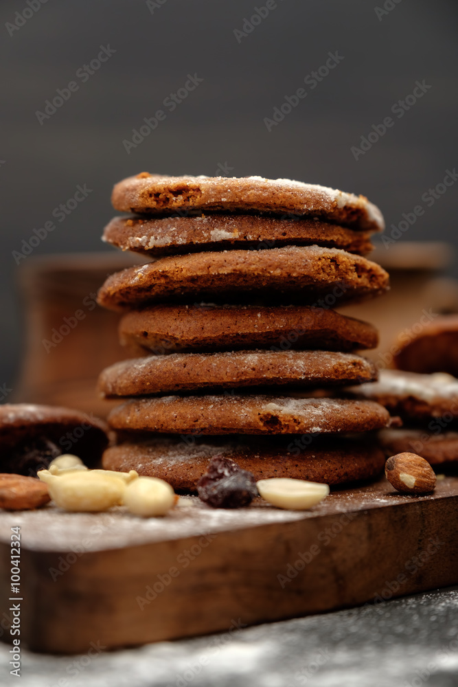 Gingerbread cookies dusted with icing sugar on a wooden table Gingerbread cookies dusted with icing sugar on a wooden table