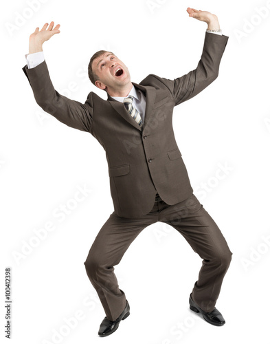 Scared businessman looking up