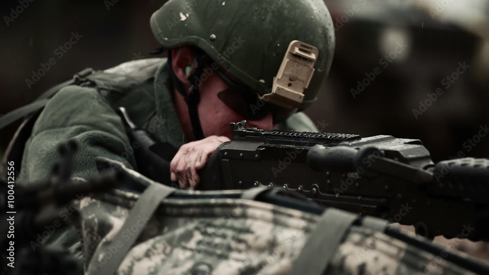 Soldier shooting machine gun in the rain Soldier shooting machine gun in the rain