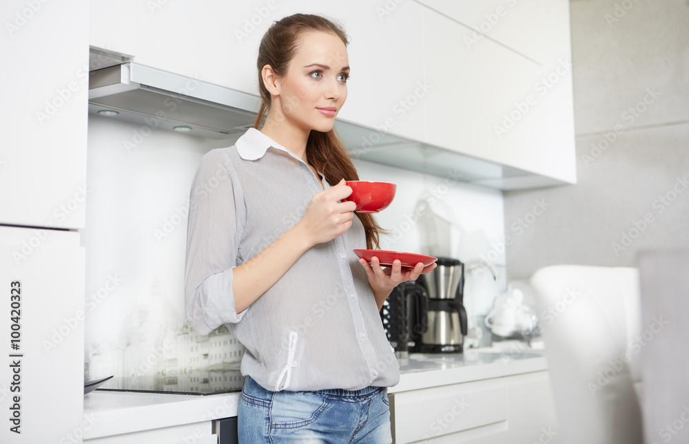 Woman drinking morning coffee in the kitchen Woman drinking morning coffee in the kitchen