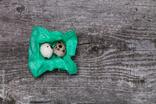 Composition with quail eggs. Wooden texture for background photo