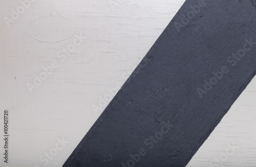 Plate slate on a white wooden board for background