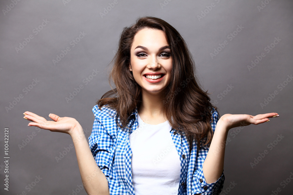 Surprised young woman over gray background Surprised young woman over gray background