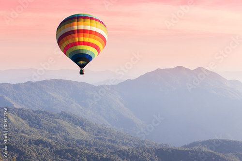 Hot air balloon above high mountain at sunset © littlestocker