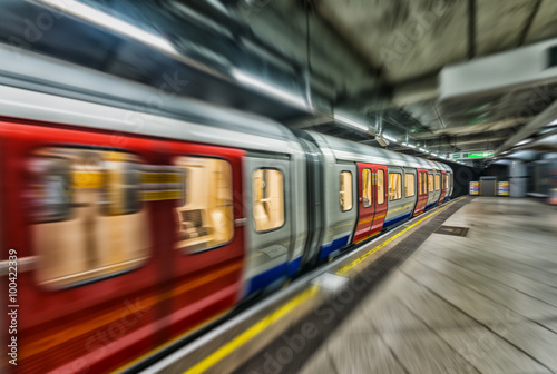 Fast moving subway train in London underground station photo