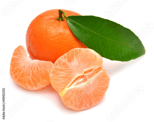 Mandarin with leaf and slices of peeled tangerine