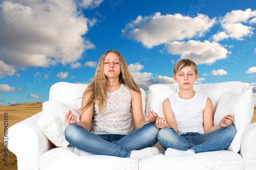 Boy and girl meditates in nature