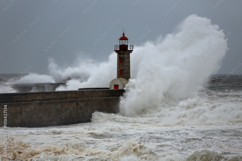 Stormy wave over lighthouses and piers