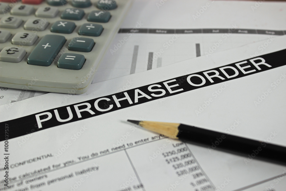 Purchase order form with pencil and calculator selective focus 