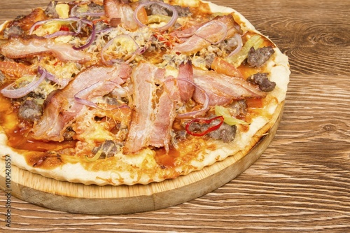 Pizza on dark wooden background. Stock image macro.