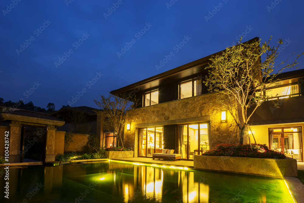 exterior of modern building near pond at night exterior of modern building near pond at night