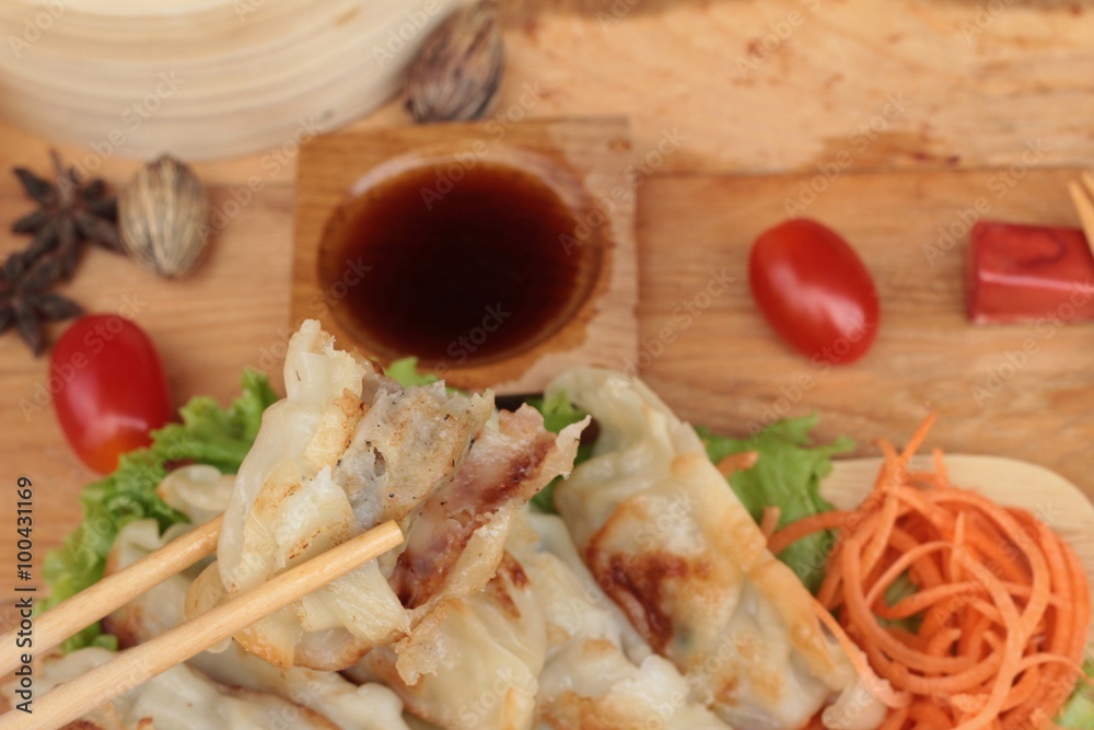 Fried gyoza and sauces - traditional Japanese food.