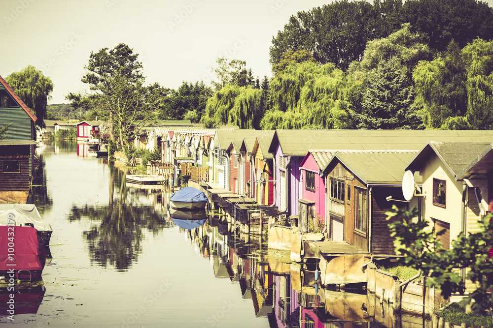 old colored boat houses in summer