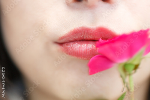 A woman's lips and red rose.