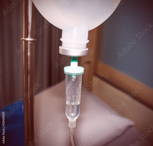 Close up IV saline solution drip for patient in hospital blur vintage color tone. © weerachaiphoto