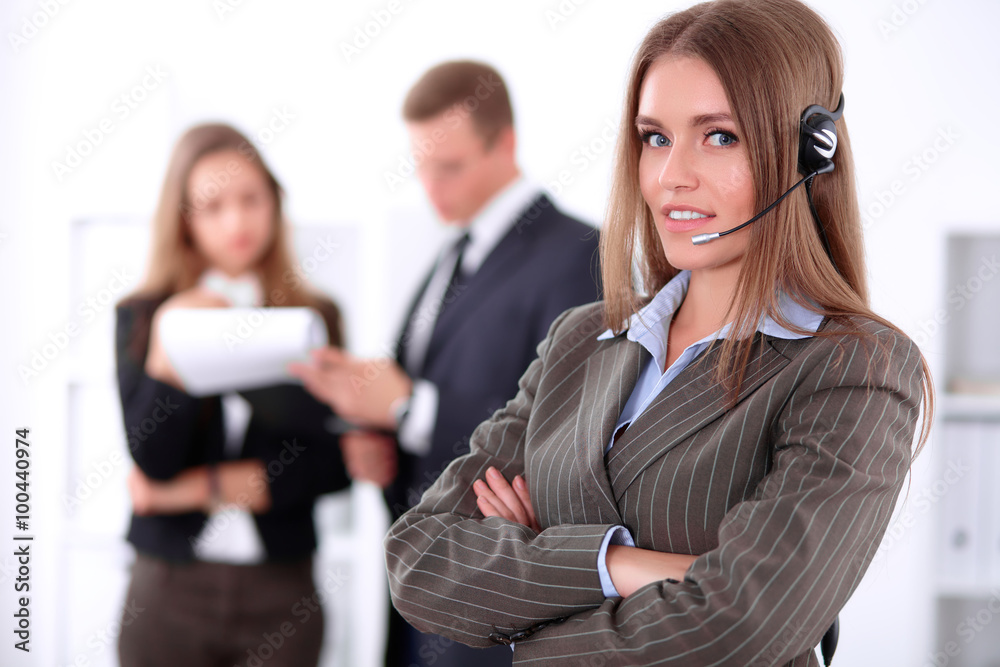Portrait of beautiful cheerful smiling call operator on the background of business people. Successful call center concept Portrait of beautiful cheerful smiling call operator on the background of business people. Successful call center concept