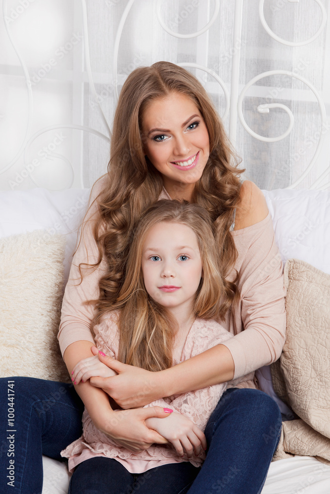 Pretty mother cuddling with daughter Pretty mother cuddling with daughter