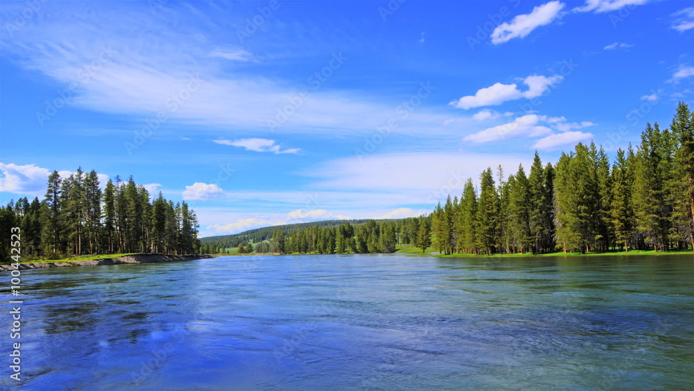 Time-lapse shot of a riverbend and pine trees on a riverbank in Utah Time-lapse shot of a riverbend and pine trees on a riverbank in Utah