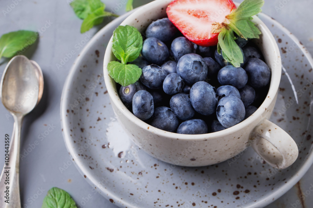 Strawberries and Blueberries on metal background Strawberries and Blueberries on metal background