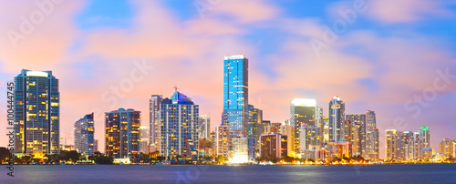 Miami Florida, sunset cityscape over the city panoramic skyline with lights on the modern downtown skyscraper buildings