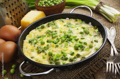Omelette with green peas, potatoes and cheese