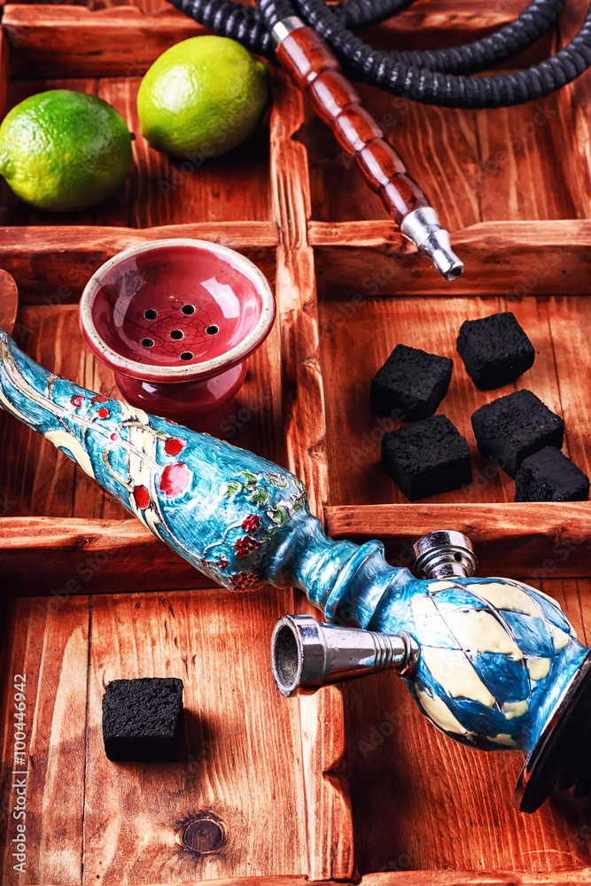 Accessories for Shisha.Dismantled parts of the hookah in stylish wooden box  with fruits lime Stock Photo