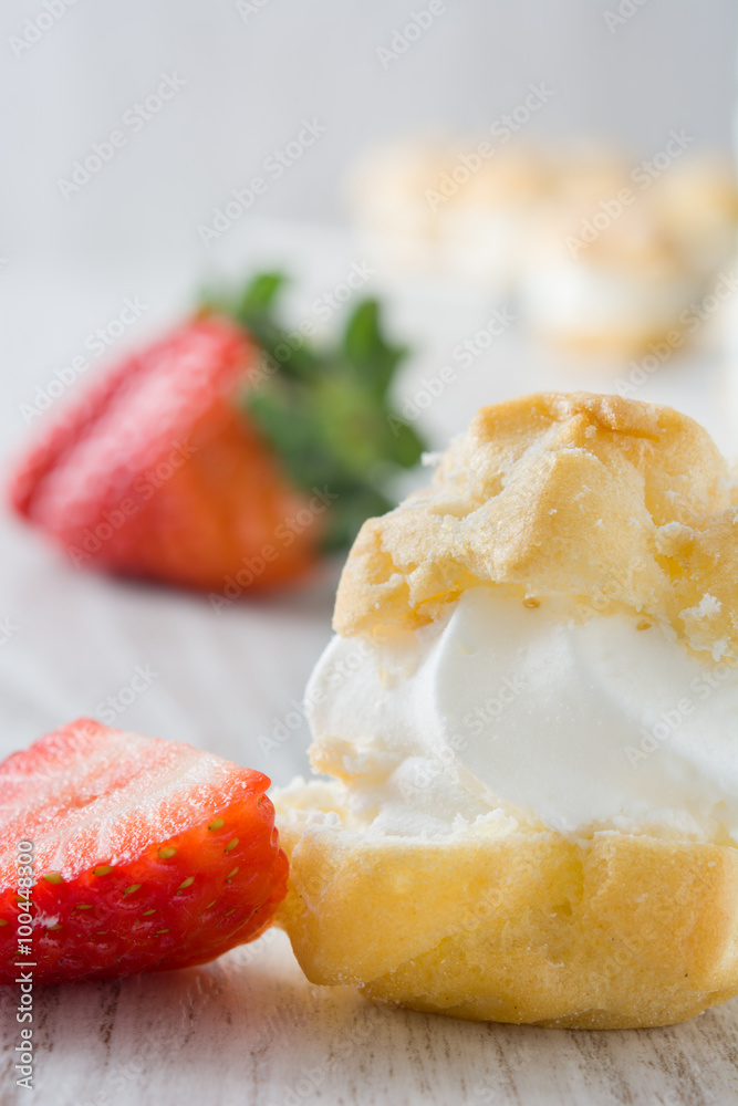 Fresh profiteroles with cream and strawberrie
Fresh profiteroles with cream and strawberrie