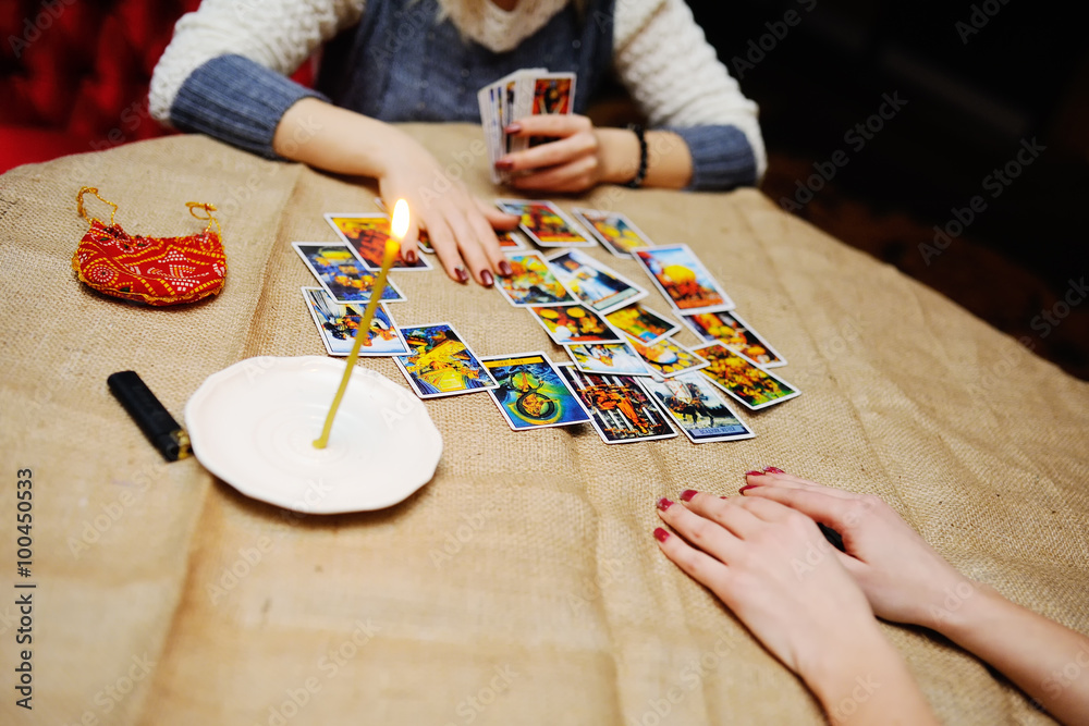 Obraz premium Divination by the Tarot cards. The fortune teller predicts the f