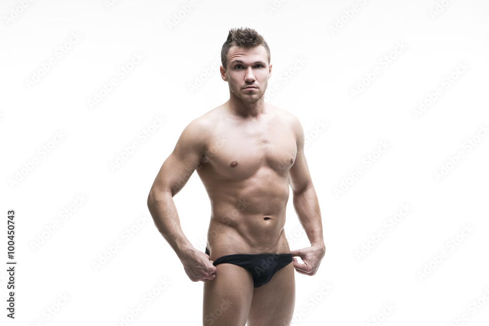 Handsome muscular bodybuilder posing on white background. Isolated studio shot