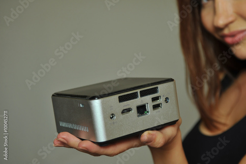 Model holding on hand mini computer with all digital ports showing functionality