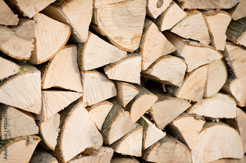 Background of dry chopped firewood logs in a pile Background of dry chopped firewood logs in a pile