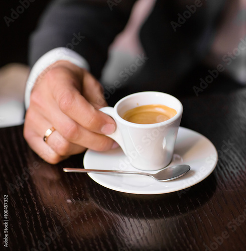 man holding hot cup of coffee