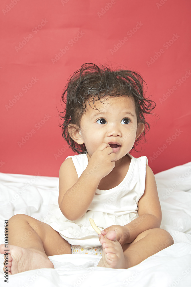 Portrait of one year old baby red background Portrait of one year old baby red background