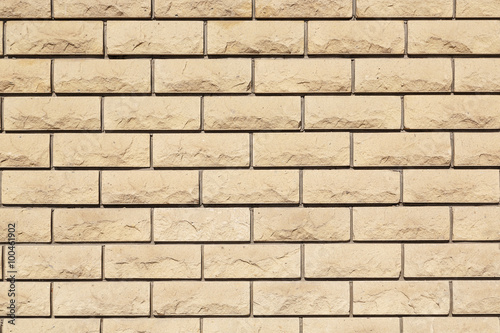 Wall of beige textured bricks