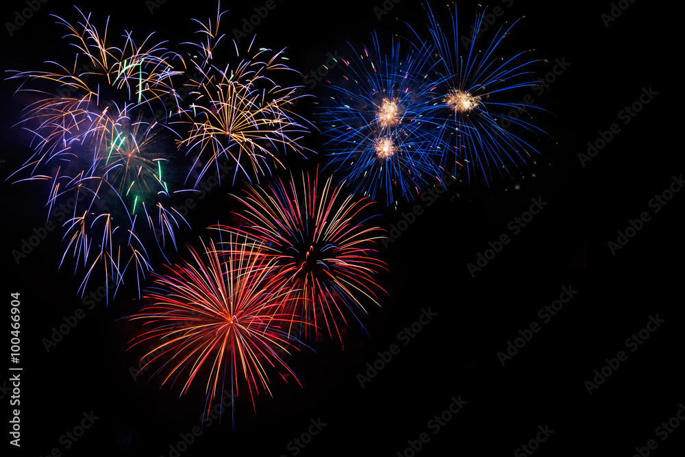 Celebration beautiful colorful red golden blue fireworks, salute with dazzling display in the night sky background. A large fireworks event. Sparks. 4 of July, Independence day, New Year. Copy space