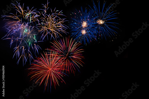 Celebration beautiful colorful red golden blue fireworks, salute with dazzling display in the night sky background. A large fireworks event. Sparks. 4 of July, Independence day, New Year. Copy space